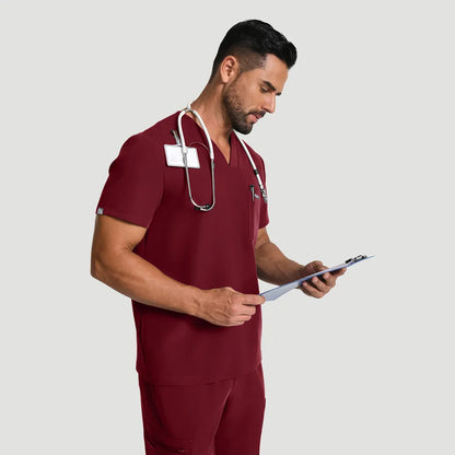 KungFu Scrubs men’s burgundy scrub set in use with stethoscope and clipboard