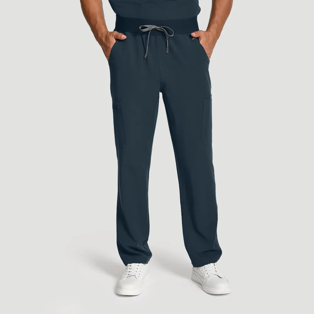 Dark Harbor men’s V-neck scrub top and pants, front view with hands in pockets.