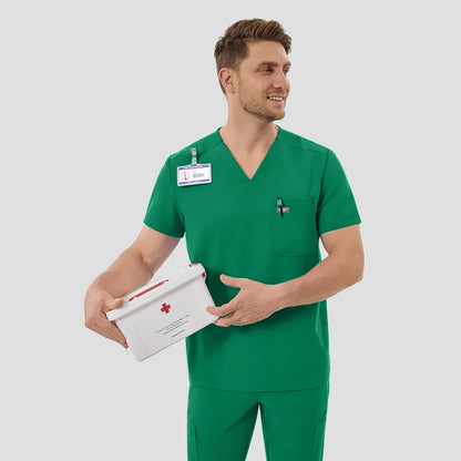 Male model smiling in Indocyanine Green scrub set, front view.