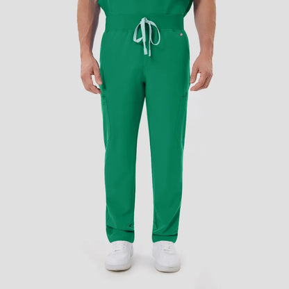 Indocyanine Green scrub pants close-up, male model hands in pockets, white background.