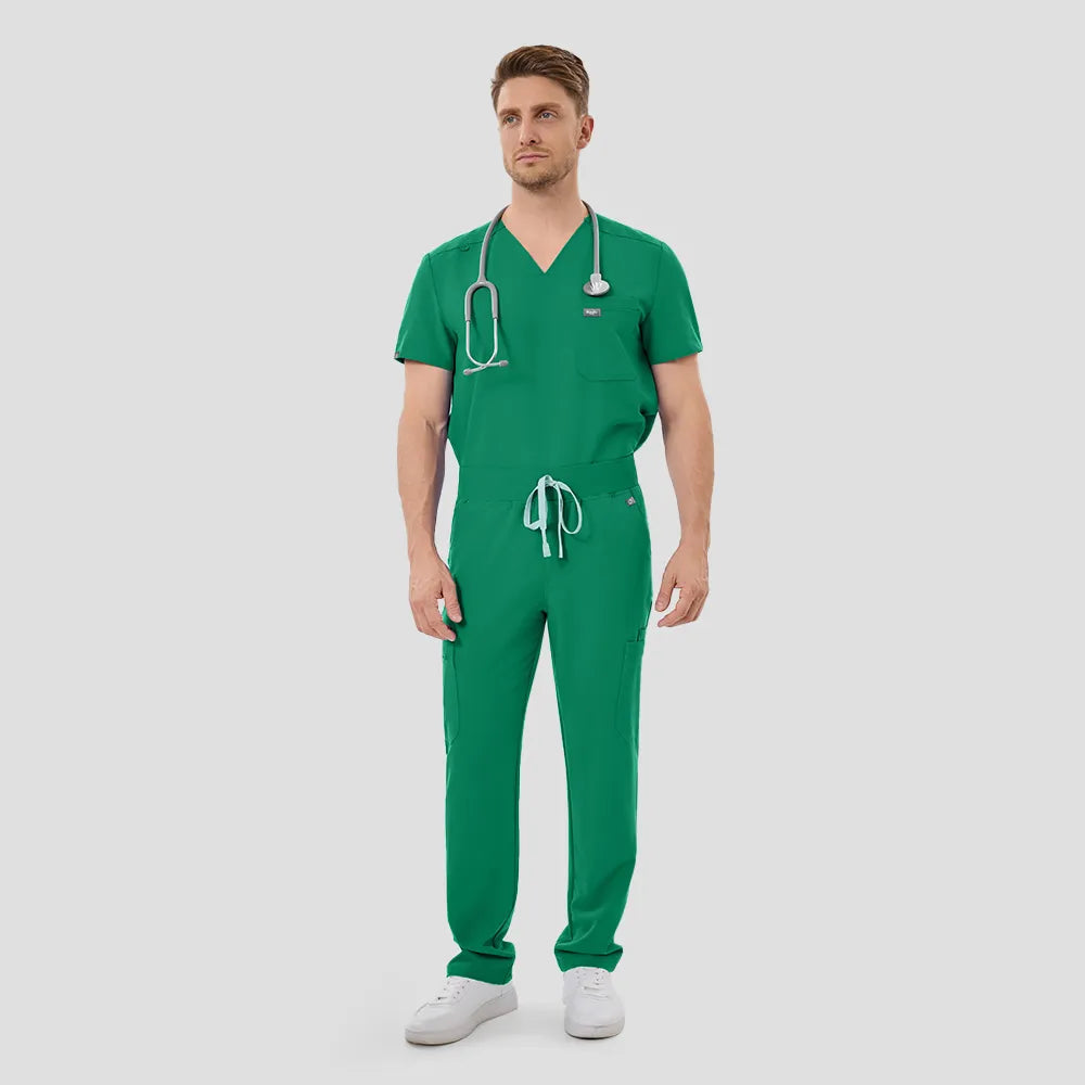 Male model walking, Indocyanine Green scrub top and pants, full body view.